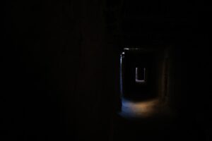 a dark tunnel with a light at the end