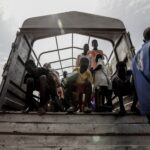 people in a white boat during daytime